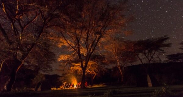 Kenya camping safari bonfire at night Overland group safari