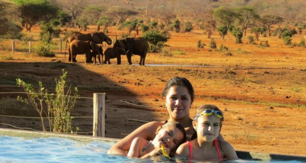 Family relaxing at the pool Kenya safari Tsavo West National Park